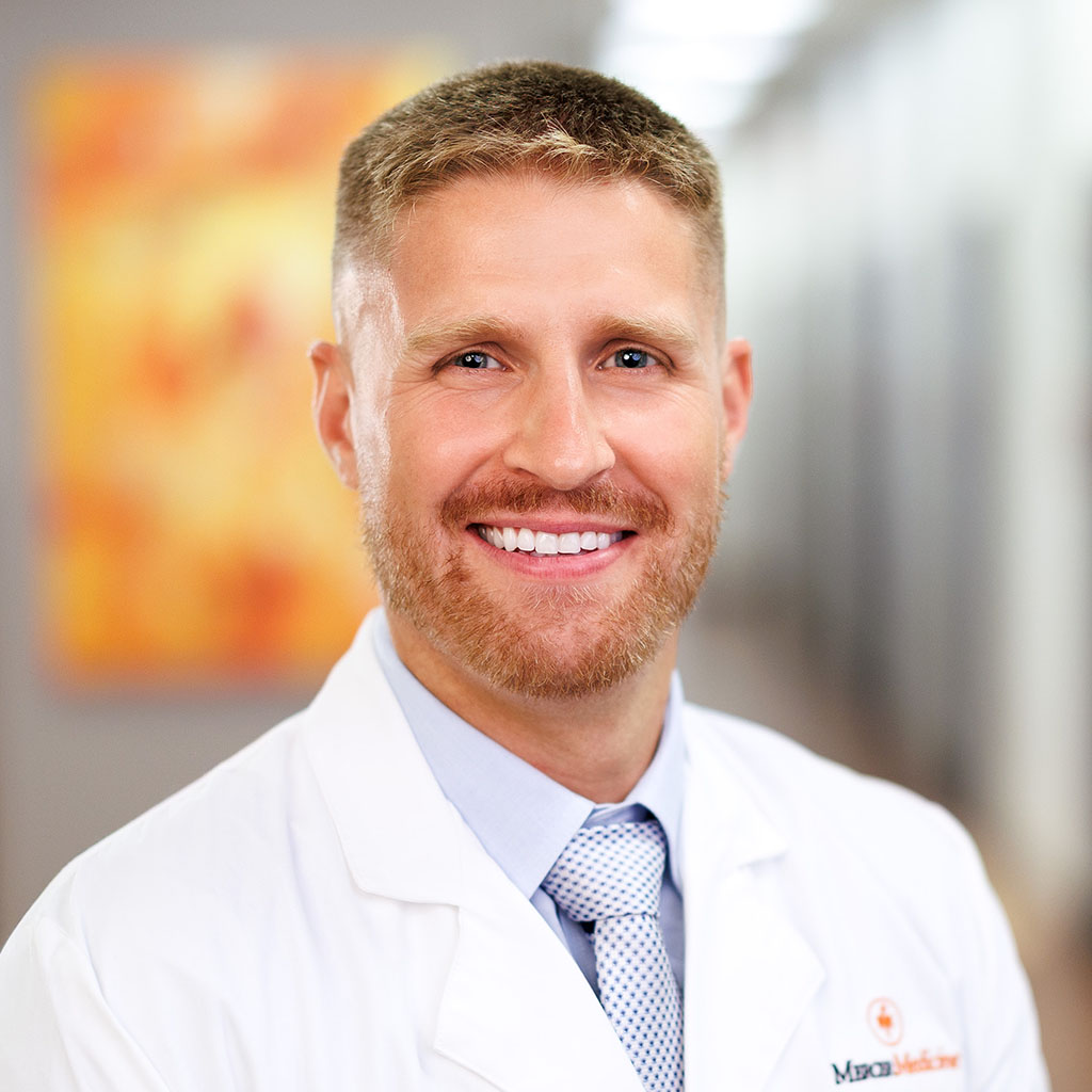 Dr. Patrick Notini smiling in a white coat while standing in a Mercer Medicine clinic.